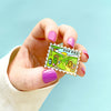 Hand holding Stamp Enamel Pin of Bag End and Hobbit Home