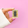 Hand Holding 221B Baker Street Detective Enamel Stamp Pin