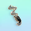 Hand holding Magical Wand Enamel In in Black with magical sparkles