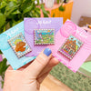 Hand Holding The Valley of the Wind, Laputa and The Bakery Enamel Pin