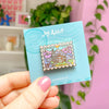 hand holding helms deep stamp enamel pin