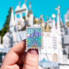Hand Holding Arenfjord Enamel Pin In front of castle