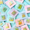 Colorful Display in frame of Mix and Match Stamp Enamel Pin Set, Porthaven, Neverland, A Galaxy Far Far Away, Tulgey Woods, The Magical Castle for Wizards, Pemberley, Wizard of Oz, The Safari Dinosaur Island, The Wardrobe, Bag End, Dune, Anne of Green Gables