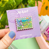 Hand Holding The Valley of the Wind Enamel Pin