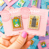 Hand holding Wardrobe Pin and 221B Baker Street Detective Enamel Stamp Pin