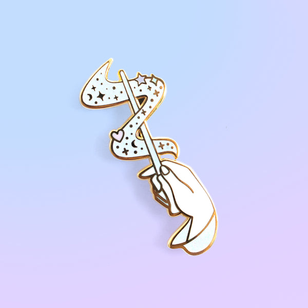 Hand holding Magical Wand Enamel In in White with magical sparkles
