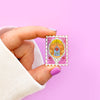 Hand holding Stamp Enamel Pin of Princess Castle, a Magical Mirror and rose