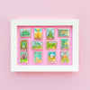 Colorful Display in frame of Mix and Match Stamp Enamel Pin Set, Porthaven, Neverland, A Galaxy Far Far Away, Tulgey Woods, The Magical Castle for Wizards, Pemberley, Wizard of Oz, The Safari Dinosaur Island, The Wardrobe, Bag End, Dune, Anne of Green Gables