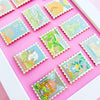 Colorful Display of Mix and Match Stamp Enamel Pin Set, Porthaven, Neverland, A Galaxy Far Far Away, Tulgey Woods, The Magical Castle for Wizards, Pemberley, Wizard of Oz, The Safari Dinosaur Island, The Wardrobe, Bag End, Dune, Anne of Green Gables