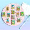 Colorful Display of Mix and Match Stamp Enamel Pin Set featuring The Unicorn forest, Baker Steet, The Wizard's Hut, Atlantica, The Tower, The Temple, The Princess Castle, Totoro Forest, The Capitol, Imladris, The Japanese Bathhouse